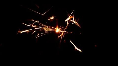 Hand sets fire a sparkler Stock Footage 247404857