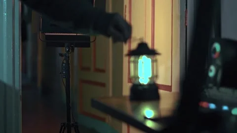 Hand Sets Lamp on Table at Night Stock Footage 309770687
