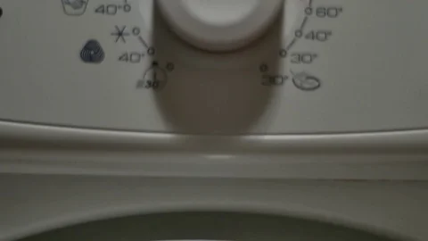 Hand Setting The Temperature On A Washing Machine's Programing Button, Tilt Stock Footage 70166455