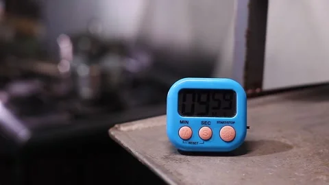 Hand setting time on a kitchen timer Stock Footage 338078605