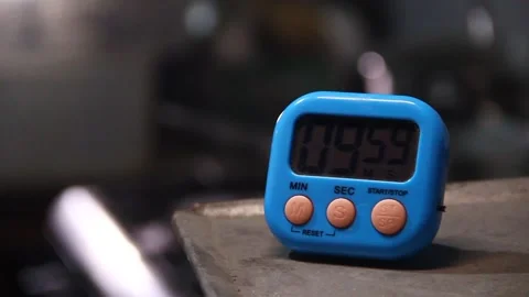 Hand setting time on a kitchen timer Stock Footage 338078757