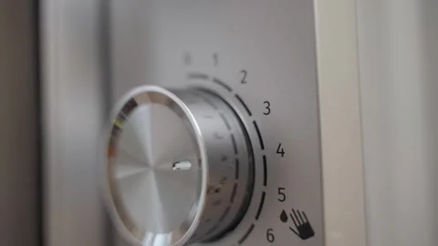 Hand setting the time on a microwave oven, close-up Stock Footage 324518199