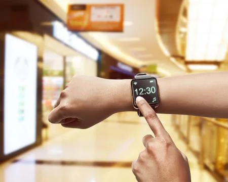 Hand setting time on smartwatch Stock Photos