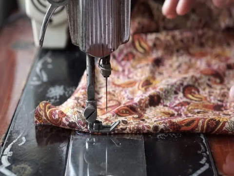 Hand is sewing the cloth using an old sewing machine. Stock Footage 92652425