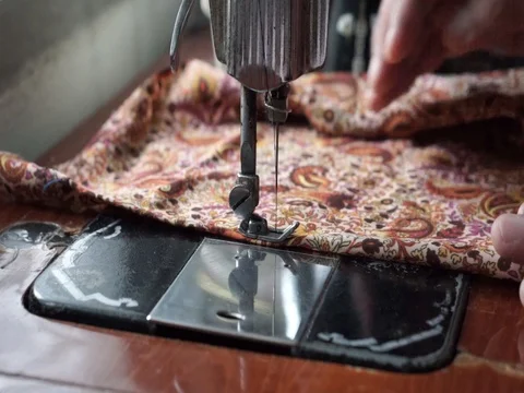Hand is sewing the cloth using an old sewing machine. Stock Footage 92652463