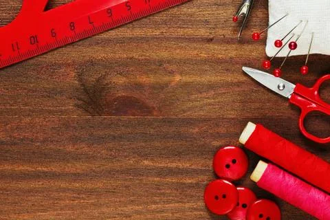 Hand sewing instruments and materials in shades of red Stock Photos