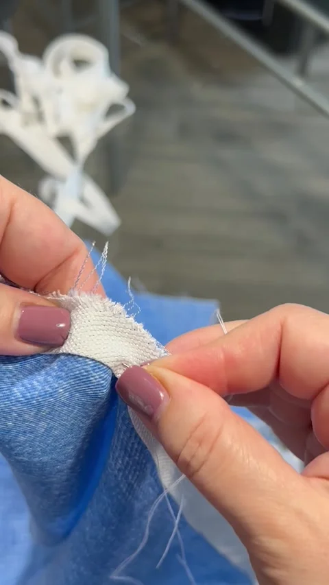 Hand sewing. Threading with a needle in the hands of a woman. Stock Footage 261806646