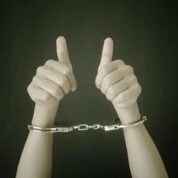 Hand in shackle Stock Photos