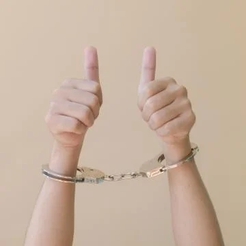 Hand in shackle Stock Photos