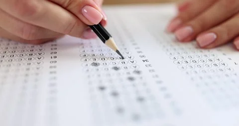 Hand shades answer sheet with pencil marking test choice Stock Footage 317166437