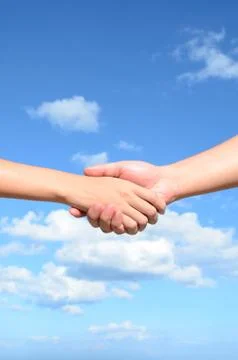 Hand shake between a man and a woman on blue sky background Stock Photos
