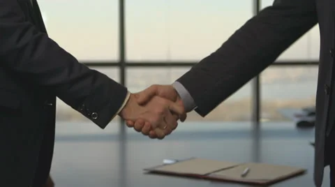 Hand shake. Business men shaking hands on a background of city Stock Footage