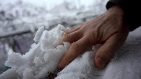 Hand shakes off lying snow. Stock Footage 99861377