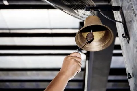 Hand is shaking bell. Foto stock