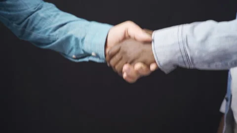 Hand shaking hands in white and black. Stock Footage 228849719