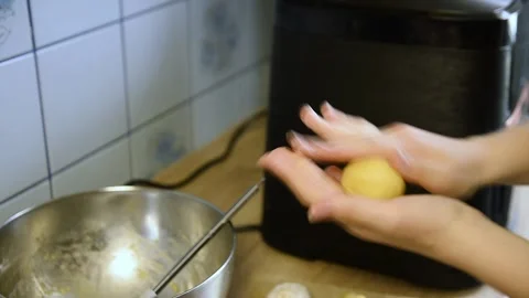 Hand shaping small dough spheres on kitchen table Stock Footage 340078104