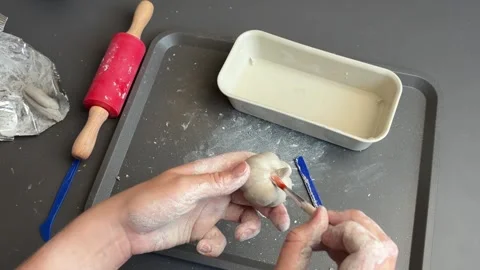 Hand shaping a textured clay pumpkin into a rustic autumn ornament Stock Footage 345720766