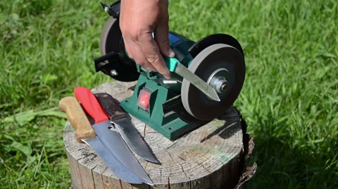 Hand sharpening with electric whetstone check  blade sharpness Stock Footage 32826664