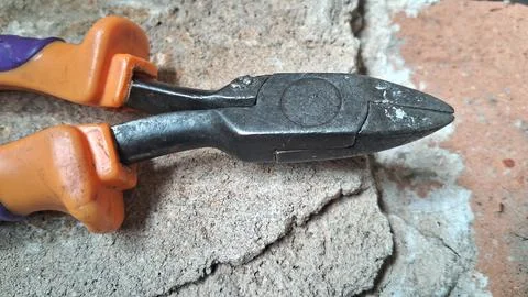 Hand sharpening a knife with a whetstone. Close-up of blade honing for precision Stock Photos