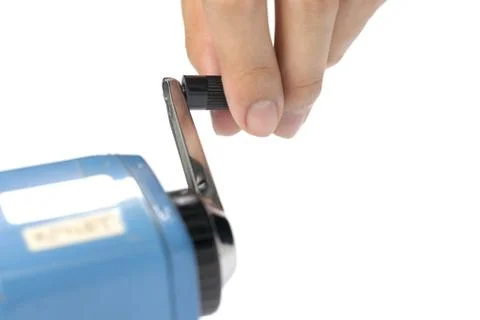 Hand Sharpening a pencil by Pencil Sharpener on white Stock Photos