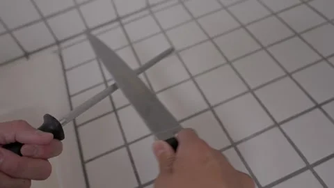 Hand sharpens knife Stock Footage 276447622