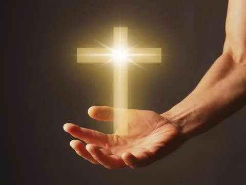 Hand with a shining cross Stock Photos