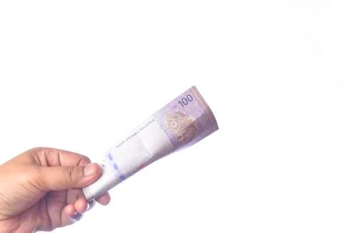 Hand showing 100 Ringgit Malaysia (MYR) money with over white  background and Stock Photos