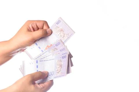 Hand showing 100 Ringgit Malaysia (MYR) money with over white  background and Stock Photos