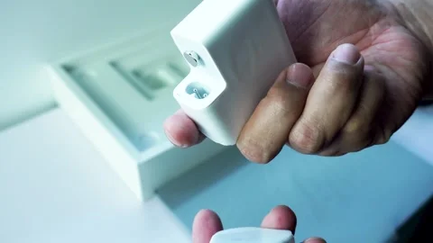 Hand Showing Apple M5 70W USB C Power Adapter Stockbeeldmateriaal 334645060