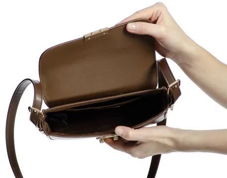 Hand showing empty brown leather bag beauty Photos