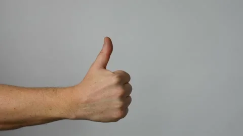 Hand showing like gesture, grey background Video stock 238355142