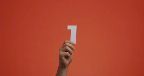 Hand showing number one. Arm with digits, first numeral made of carved paper for Video stock 156970662