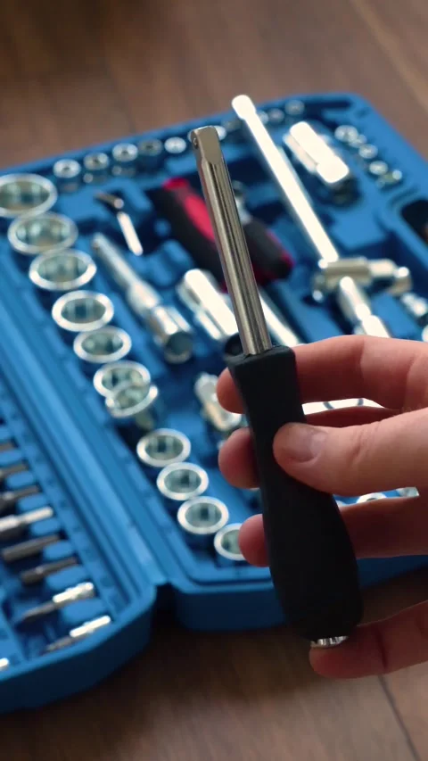 Hand showing a screwdriver in front of an open blue toolbox Stock Footage 346234856