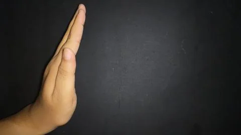 Hand by showing a stop or warning gesture.Isolated on black background Stock Photos