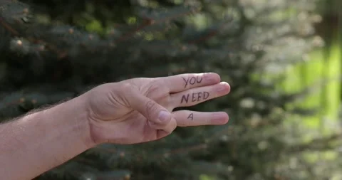 A hand is shown in a fist, as it opens the words you need a coffee apear in each Video stock 276662115
