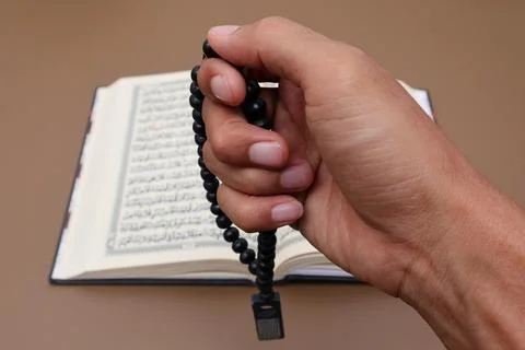 The hand that shows the gesture of praying while holding a prayer beads Stock Photos
