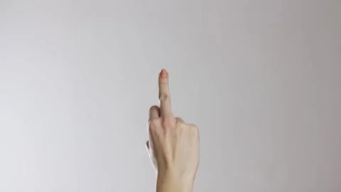 The hand shows the middle finger. Close up. Isolated on a gray background. Stock Footage 141367576
