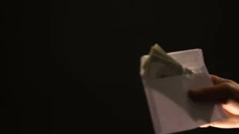 Hand shows stop gesture to envelope with dollars, refusing corrupt money, bribe Stock Footage 105047549