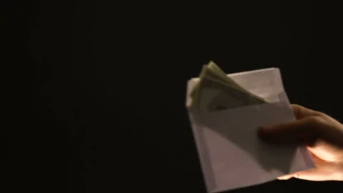 Hand shows stop gesture to envelope with dollars, refusing corrupt money, bribe Stock Footage 105049649