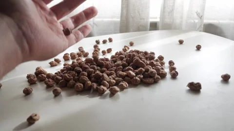 Hand Sifting and Sorting Tiger Nuts on White Table in Soft Natural Indoor Light Stock Footage 336477633