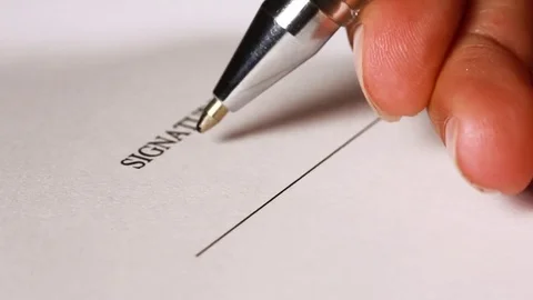Hand signing a contract in black ink. Close up. Stock Footage