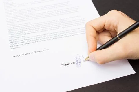 Hand signing a contract Stock Photos