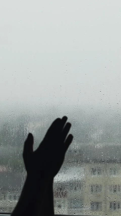 Hand silhouette on rainy window background close up. Vertical layout of win.. Stock Footage 337346771