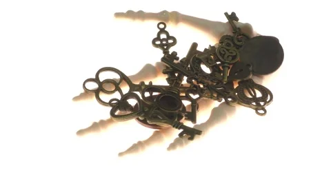 In the hand of a skeleton pirate passing in front of the camera are keys and coi Stock Footage 136571747