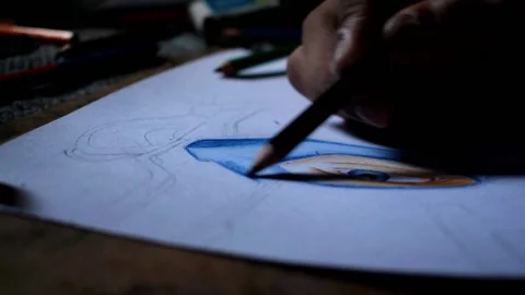 A hand sketching or drawing with color pencils on a white paper Stock Footage 131079720