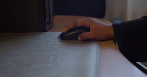 A hand skillfully using a computer mouse on a desk, showcasing modern technology Stock Footage 310519786