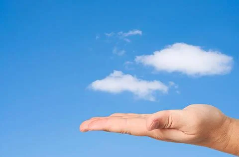 Hand in sky clouds background. Hand in sky clouds background. Concept of e... Stock Photos