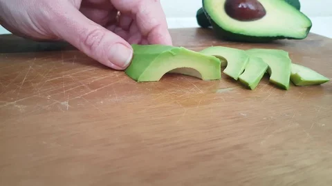 Hand slice avocado on wooden Stock Footage 86855732