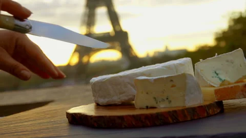 Hand slices brie cheese into sections on a board Video stock 118506041