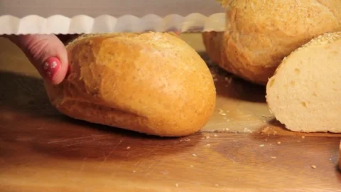 Hand slices white bread Stock Footage 84474306